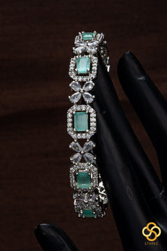 Diamond pattern with pastel green stone