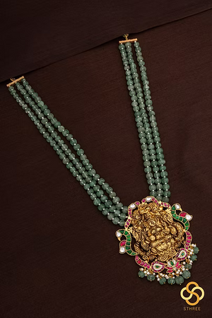 Lakshmi pendant in three liner green beads