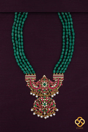 Makarakanthi pendant in four lines green beads