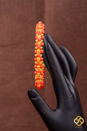 Coral and gold ball kada