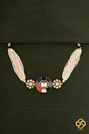 Navarathna and kundan pendant with a bunch of pearls