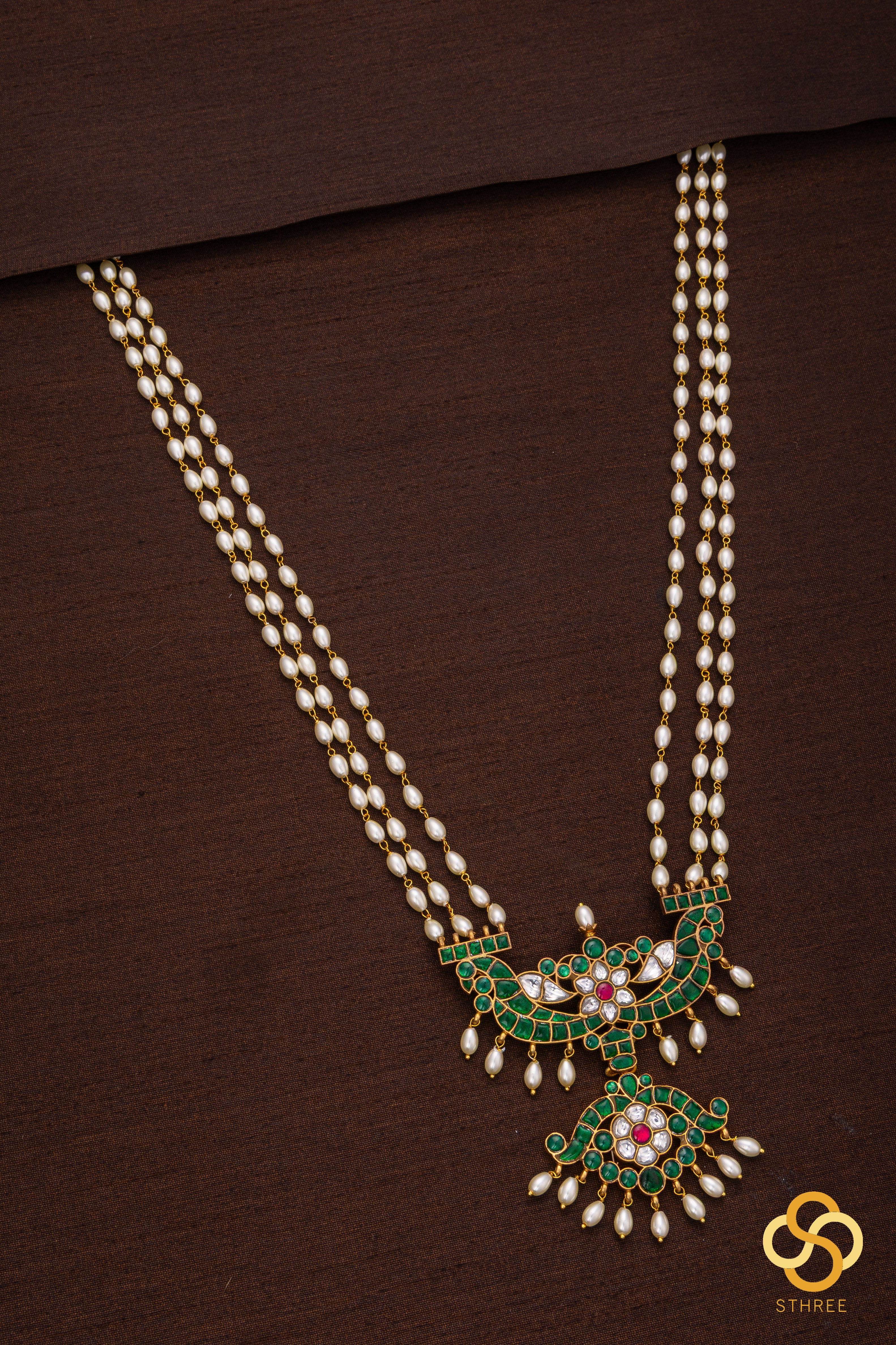 Three liner pearls with Emerald green pendant