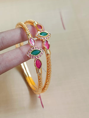 Gold kada with red and green stones