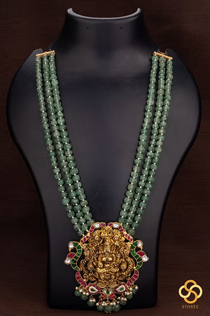 Lakshmi pendant in three liner green beads