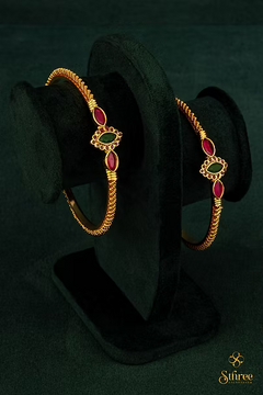 Gold kada with red and green stones