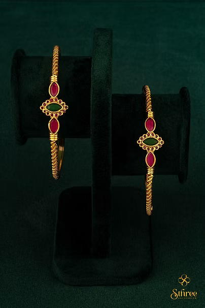 Gold kada with red and green stones